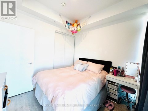 Bedroom with a bed, desk, and chair.