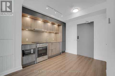 A modern kitchen with wooden cabinets and stainless steel appliances.