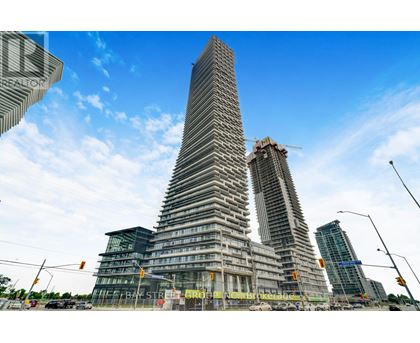 A modern skyscraper under construction with a unique triangular shape.