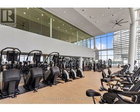 A gym with a row of stationary bikes.