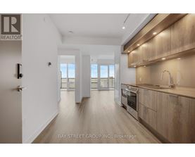 A modern kitchen with wooden cabinets and a stainless steel oven.