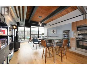 A modern kitchen with a dining table and chairs.