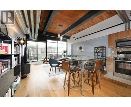 A modern kitchen with a dining table and chairs.