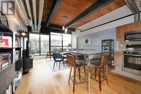 A modern kitchen with a dining table and chairs.