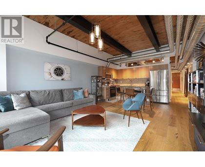 A living room with a grey couch and a wooden coffee table.