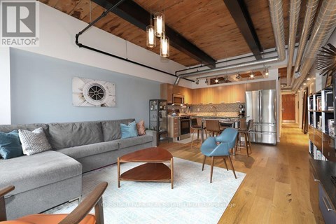 A living room with a grey couch and a wooden coffee table.