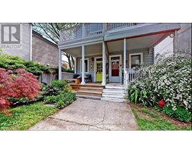 A house with a front porch and a sign that says REALTOR.