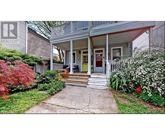 A house with a front porch and a sign that says REALTOR.