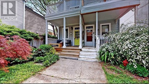 A house with a front porch and a sign that says REALTOR.