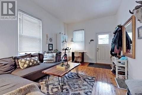 A living room with a brown couch and a wooden coffee table.