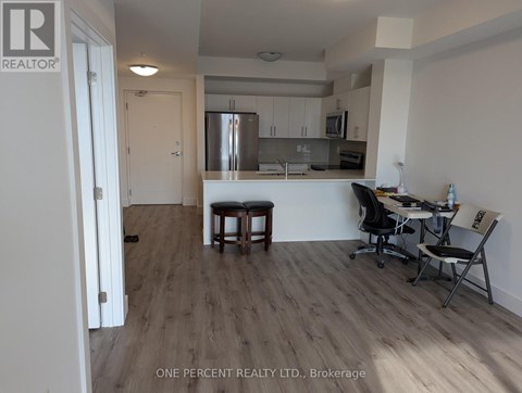 A kitchen with a table and chairs in the middle of the room.