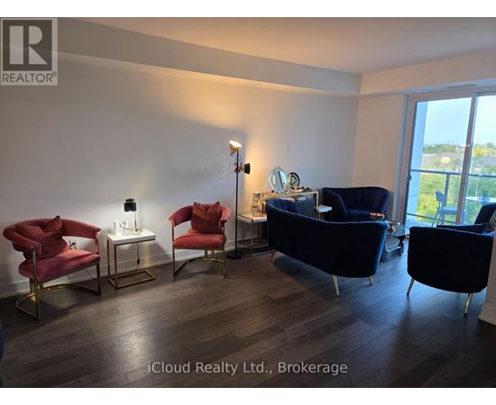 A living room with a blue couch and red chairs.