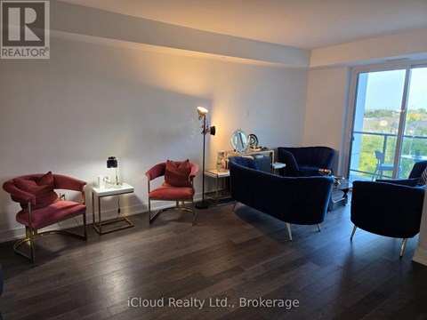 A living room with a blue couch and red chairs.