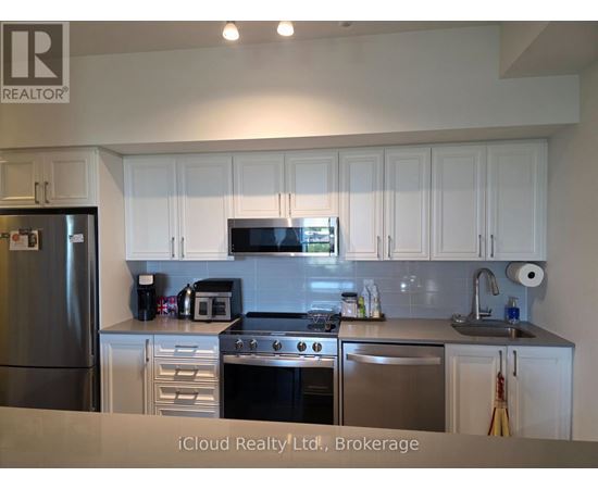 A kitchen with white cabinets and stainless steel appliances.