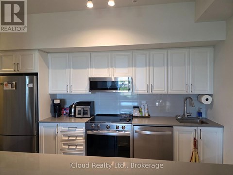 A kitchen with white cabinets and stainless steel appliances.