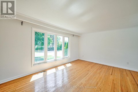 A room with wooden floors and a large window.