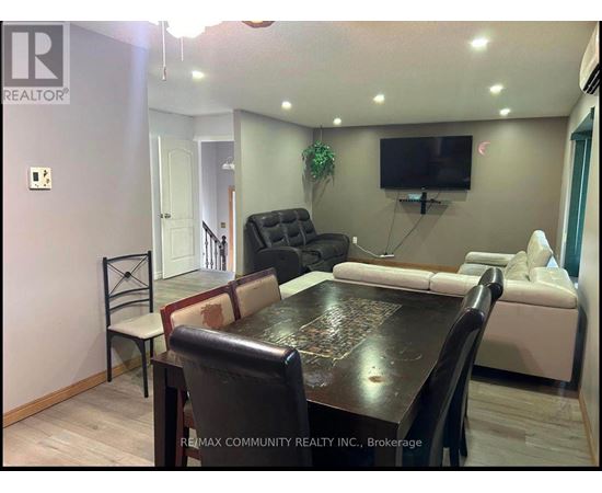 A living room with a black table and a white couch.