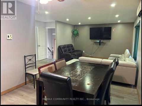 A living room with a black table and a white couch.