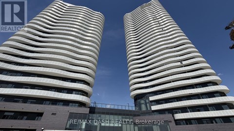 Two tall buildings with the text RE/MAX DASH REALTY Brokerage in front of them.