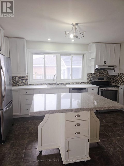 A kitchen with white cabinets and a marble countertop.