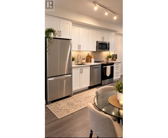 A modern kitchen with a glass table and stainless steel appliances.