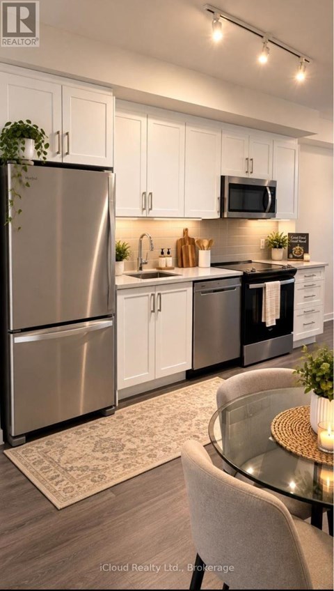 A modern kitchen with a glass table and stainless steel appliances.