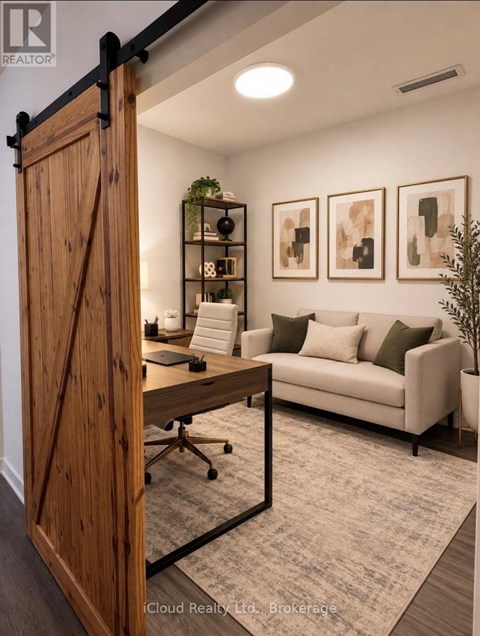 A room with a wooden door, a couch, a desk, and some plants.