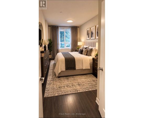 A bedroom with a large bed and a window with curtains.