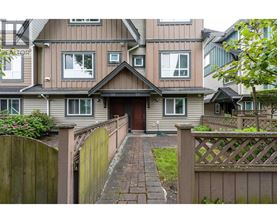 A house with a brown fence and a brick pathway leading to the front door.