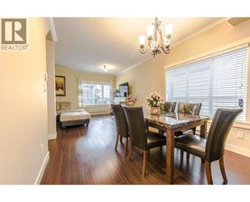 A dining room with a table set for four.