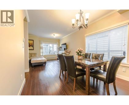A dining room with a table set for four.