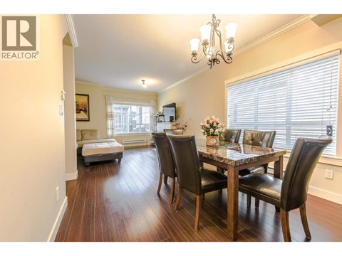 A dining room with a table set for four.