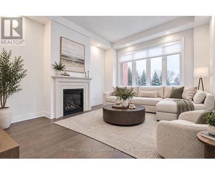 A living room with a fireplace and a painting on the wall.