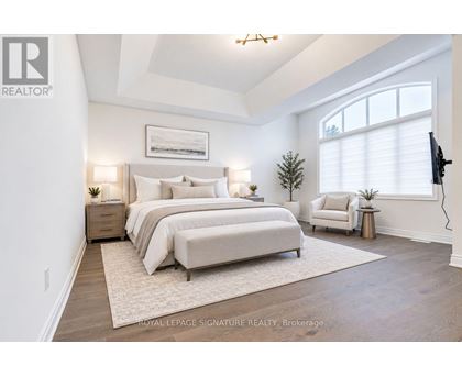 A bedroom with two beds and a television on the wall.