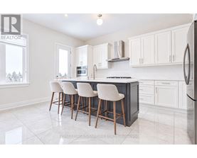 A kitchen with white cabinets and a black countertop.