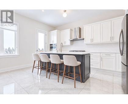 A kitchen with white cabinets and a black countertop.