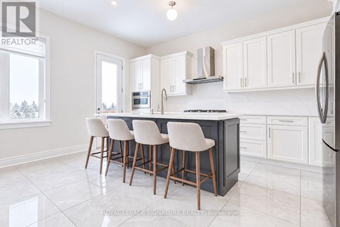 A kitchen with white cabinets and a black countertop.