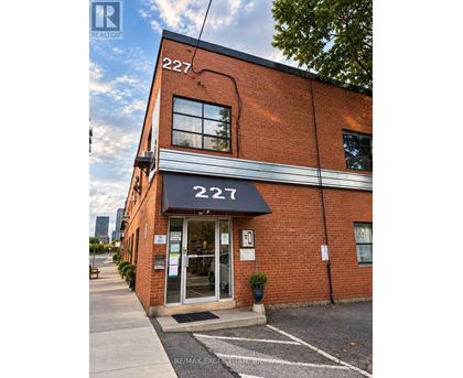 The building number 227 is a red brick building with a black awning.
