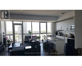 A modern kitchen with a bar stool and a view of the city.