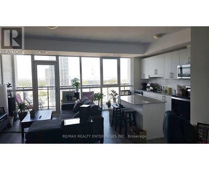 A modern kitchen with a bar stool and a view of the city.