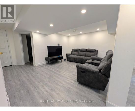 A living room with a grey sofa and a television.