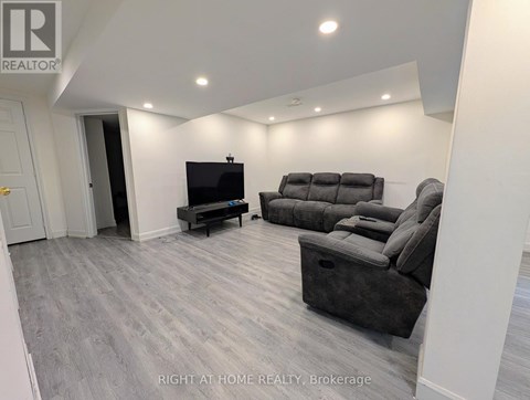 A living room with a grey sofa and a television.