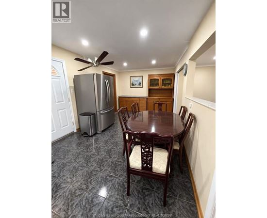 A kitchen with a table and chairs.