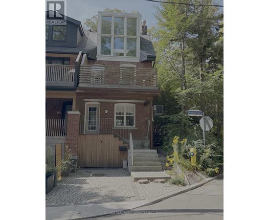 A house with a balcony and a window with shutters.