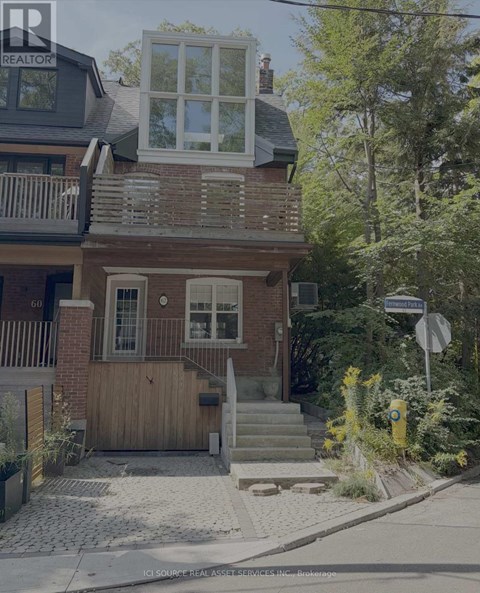 A house with a balcony and a window with shutters.