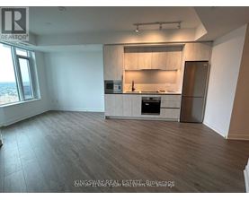 A kitchen area with a sink, stove, and cabinets.