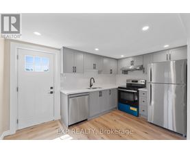 A kitchen with a white door and a window.