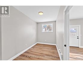 A room with a wooden floor and a white door.