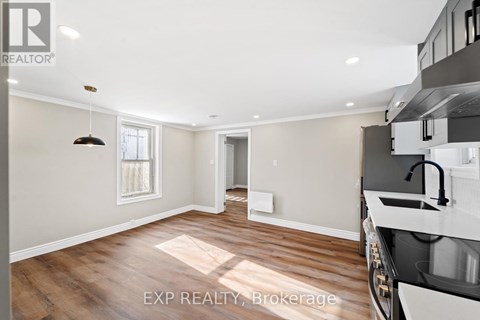 A kitchen with a sink and a window.
