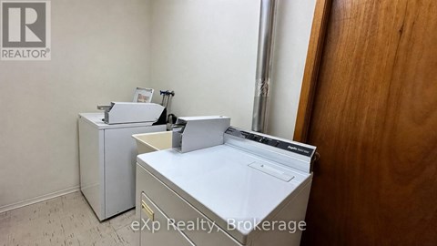 A white washing machine and dryer in a small room.